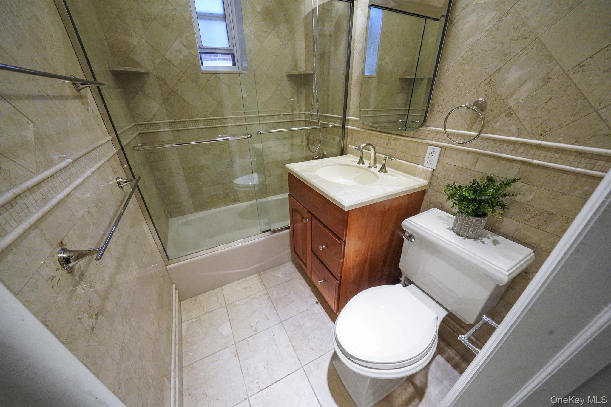 640 West 231st Street, Unit 1F Bronx, NY 10463 - Photo 12 of 17 a bathroom with a sink a toilet and shower