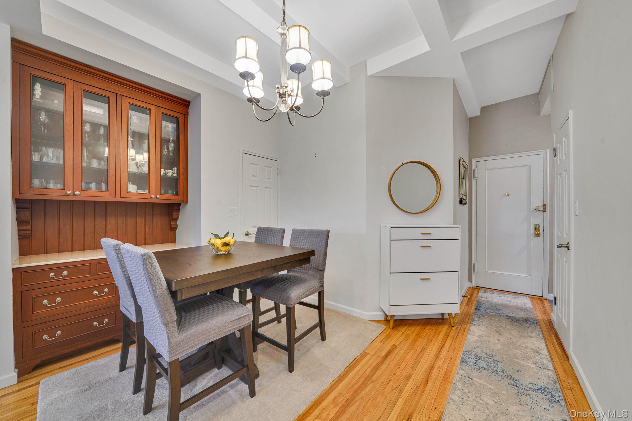 640 West 231st Street, Unit 1F Bronx, NY 10463 - Photo 2 of 17 a view of a dining room with furniture a chandelier and wooden floor