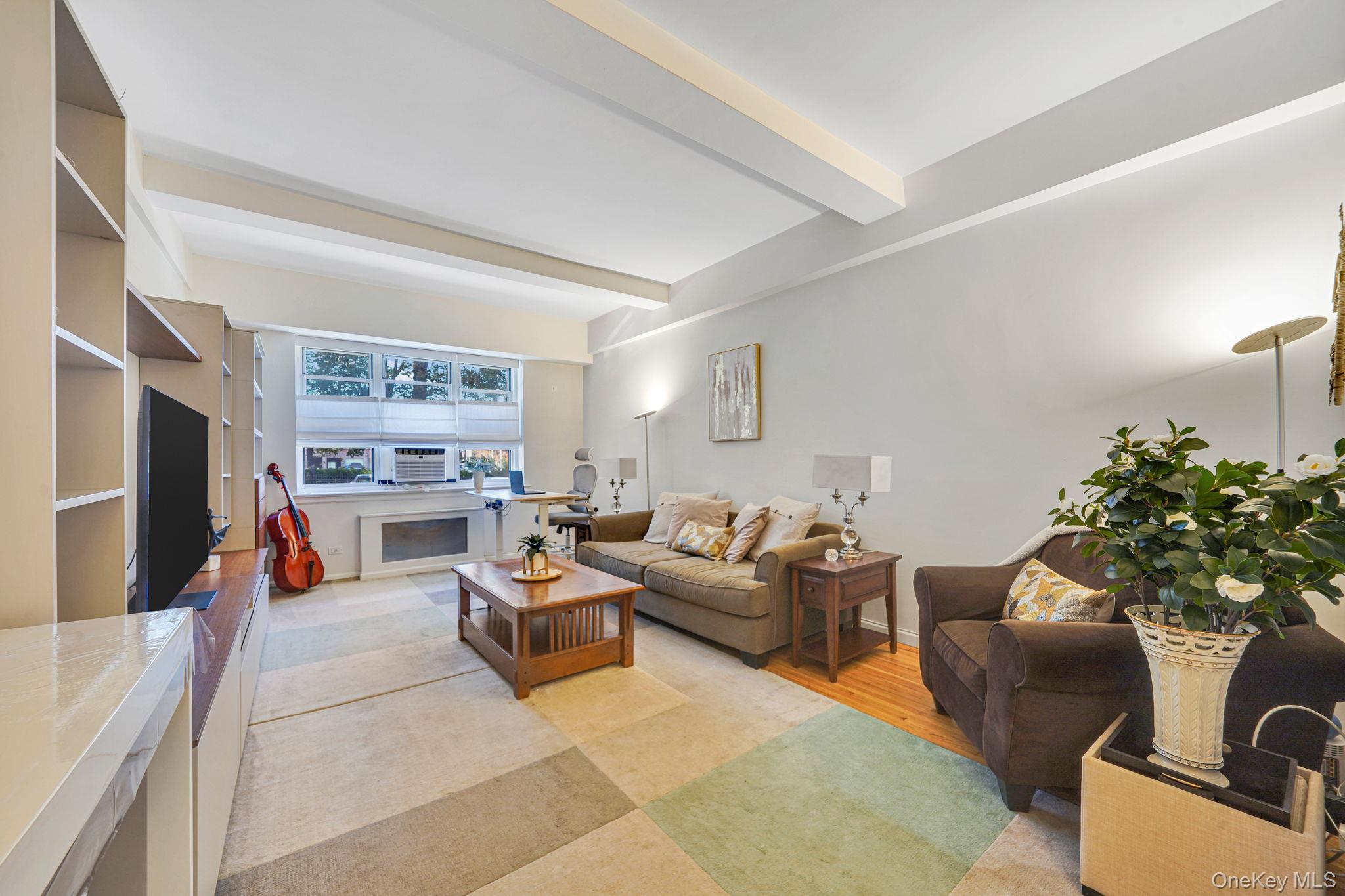 640 West 231st Street, Unit 1F Bronx, NY 10463 - Photo 4 of 17 a living room with furniture and a flat screen tv