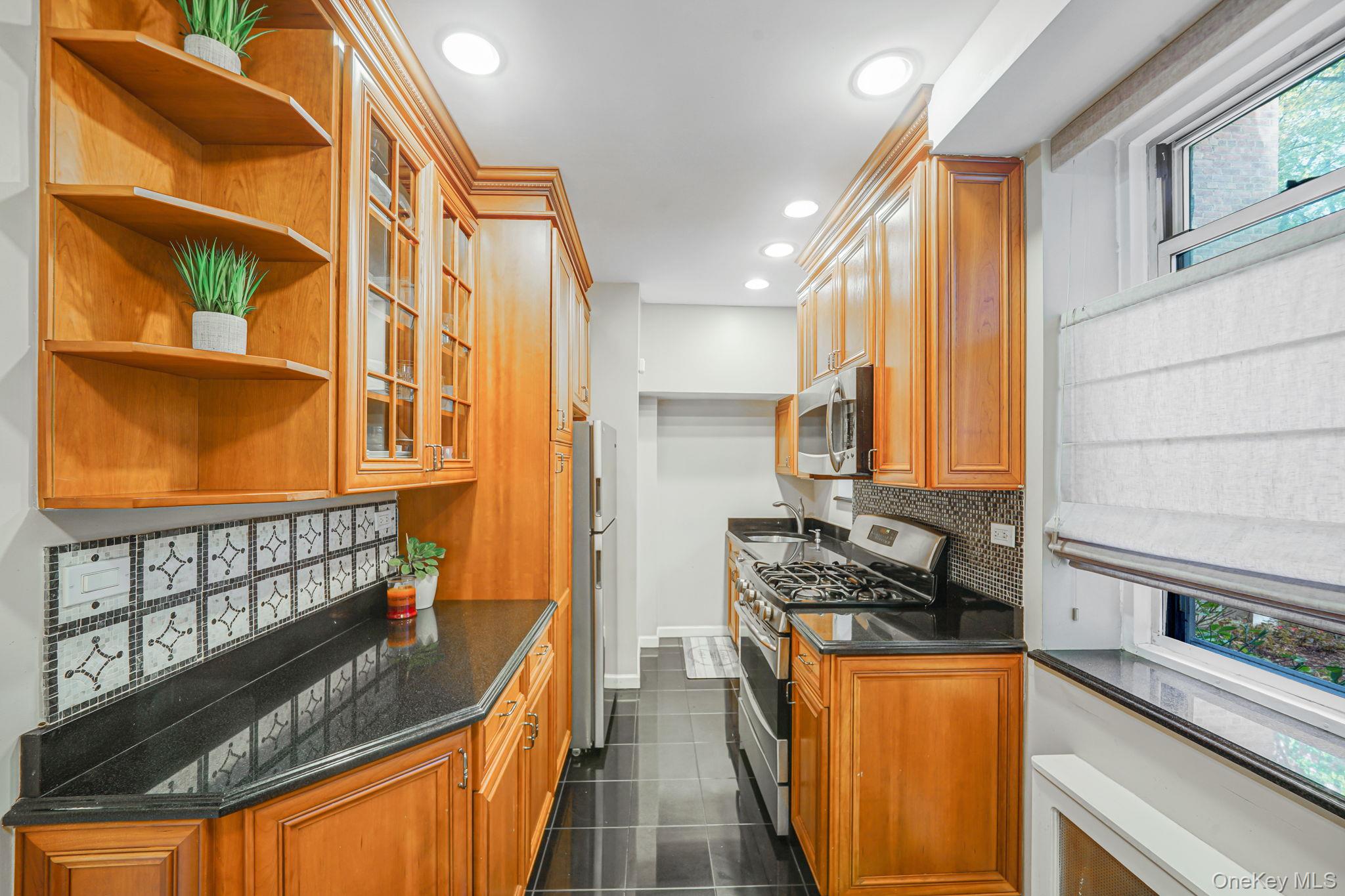 640 West 231st Street, Unit 1F Bronx, NY 10463 - Photo 8 of 17 a kitchen with stainless steel appliances granite countertop a stove a sink and a refrigerator