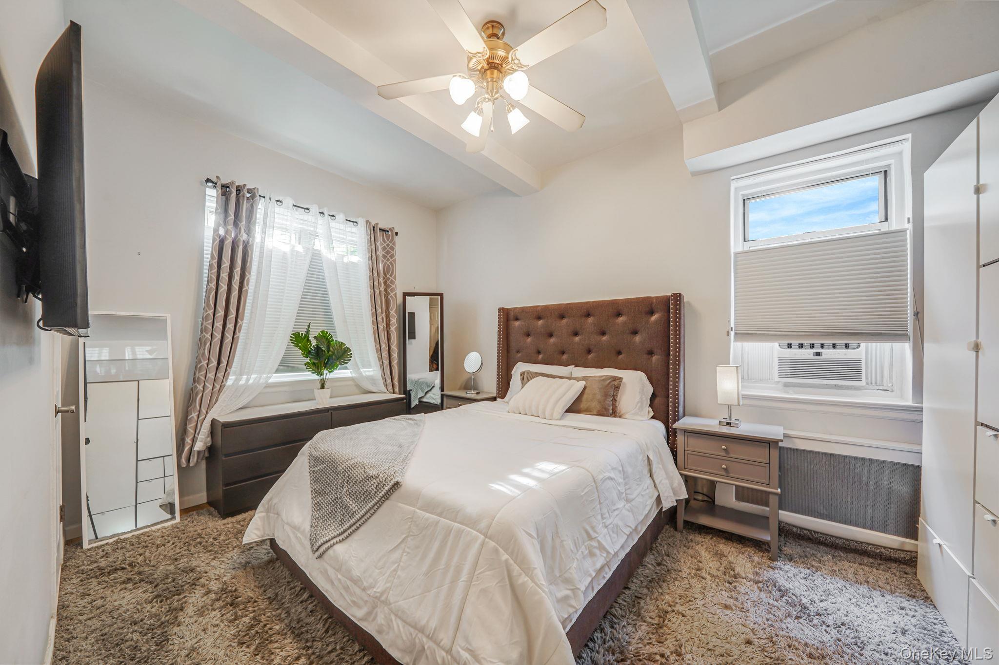 640 West 231st Street, Unit 1F Bronx, NY 10463 - Photo 9 of 17 a bedroom with a bed table and a window