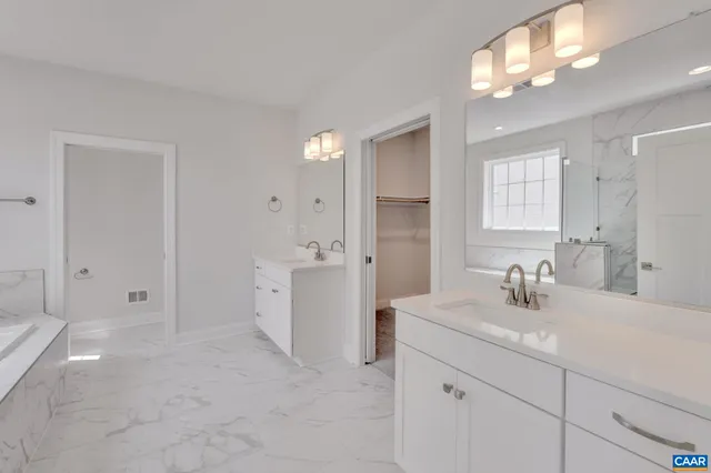 a spacious bathroom with a tub shower and window