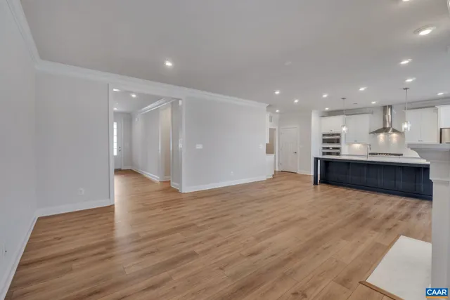 a view of kitchen and kitchen with a sink wooden floor and window