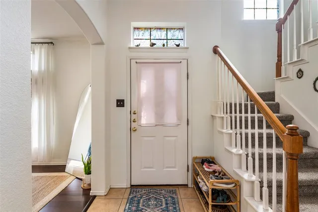 a view of a hallway with windows and stairs