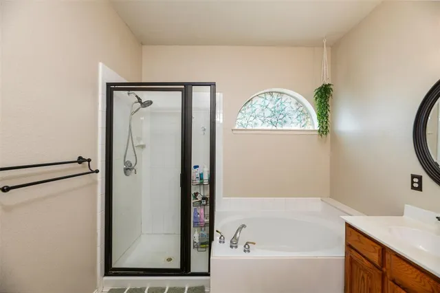 a bathroom with a bathtub and a shower
