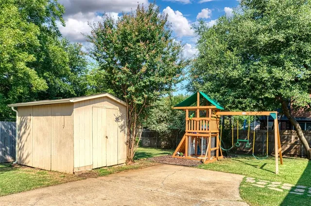 a view of backyard with small cabin