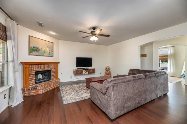 a living room with furniture a fireplace and a flat screen tv