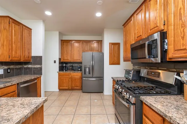 a kitchen with a stove a sink and a refrigerator