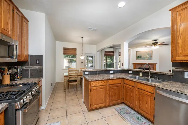 a kitchen with a sink stove top oven and cabinets