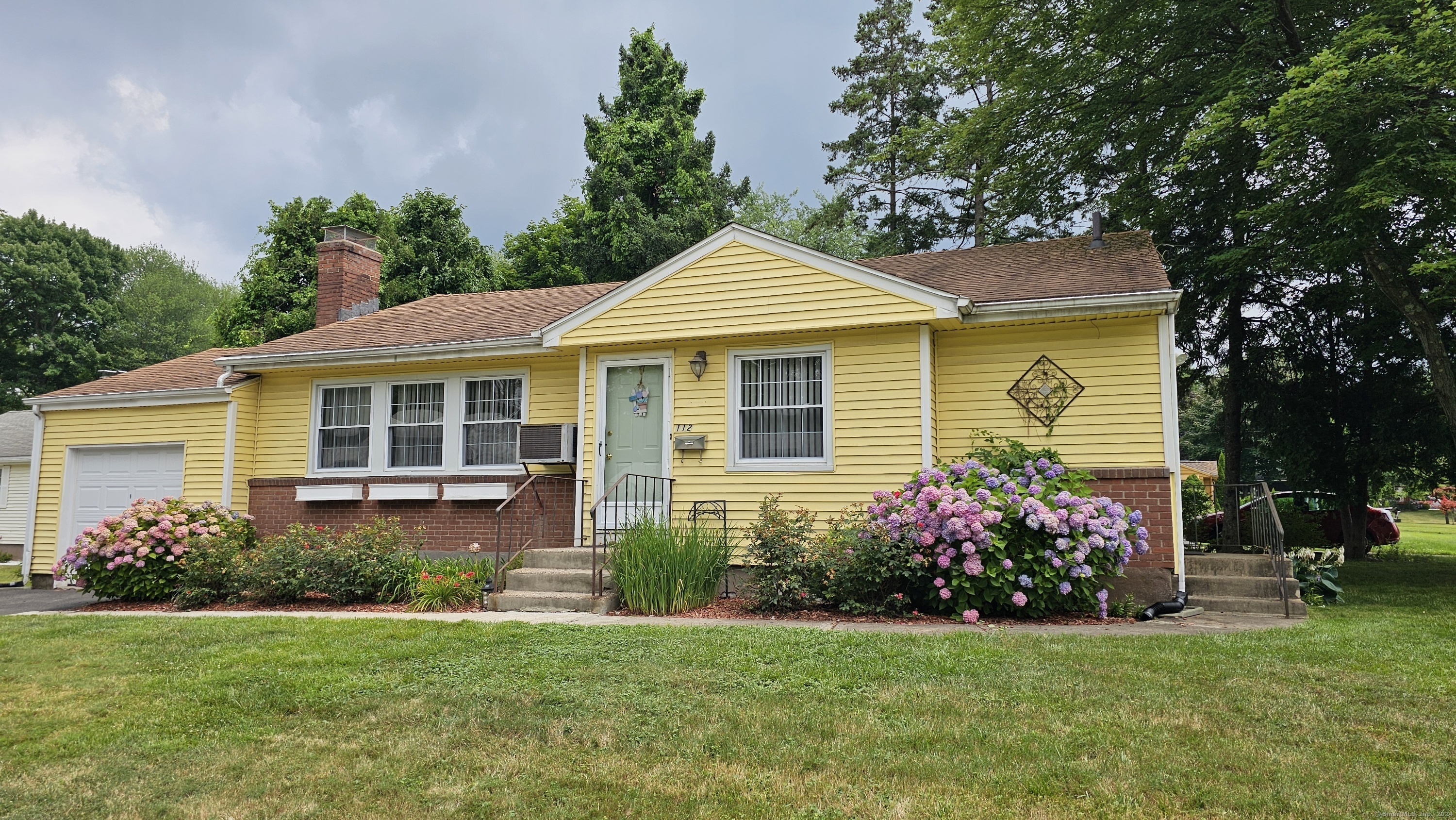 112 Bunce Road Wethersfield, CT 06109 - Photo 1 of 1 a front view of a house with garden