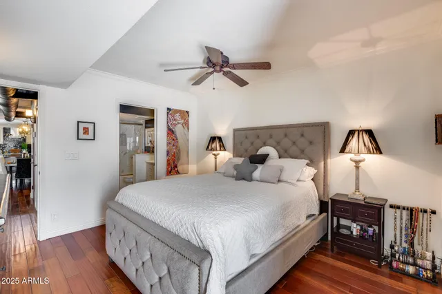 a bedroom with a bed and wooden floor