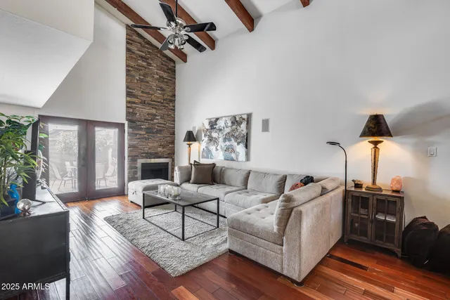 a living room with furniture and a wooden floor