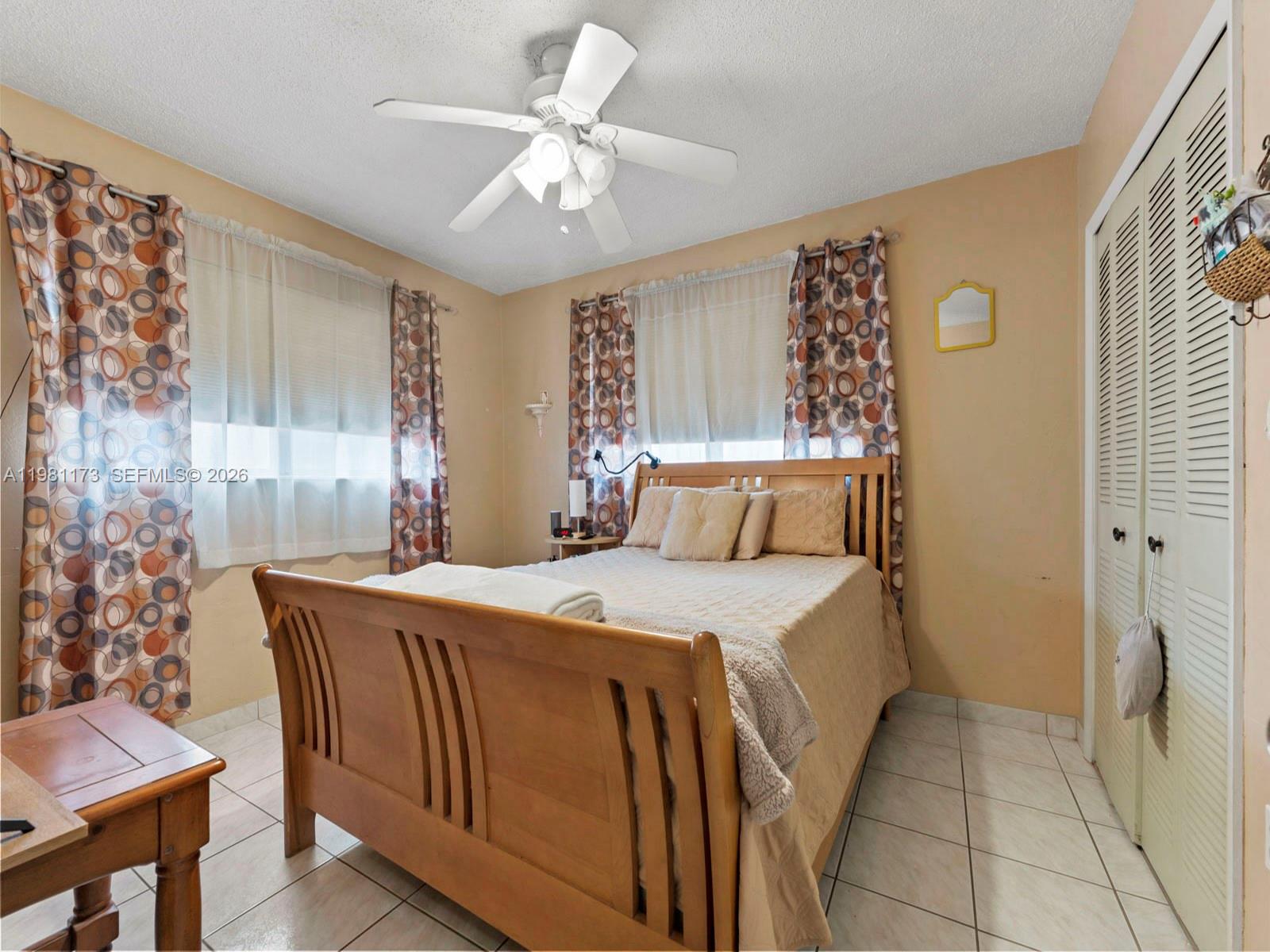 27 East 12th Street Hialeah, FL 33010 - Photo 11 of 24 a bedroom with a bed and a chandelier