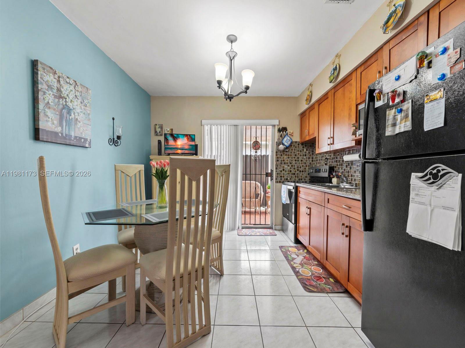 27 East 12th Street Hialeah, FL 33010 - Photo 13 of 24 a dining room with furniture and a chandelier