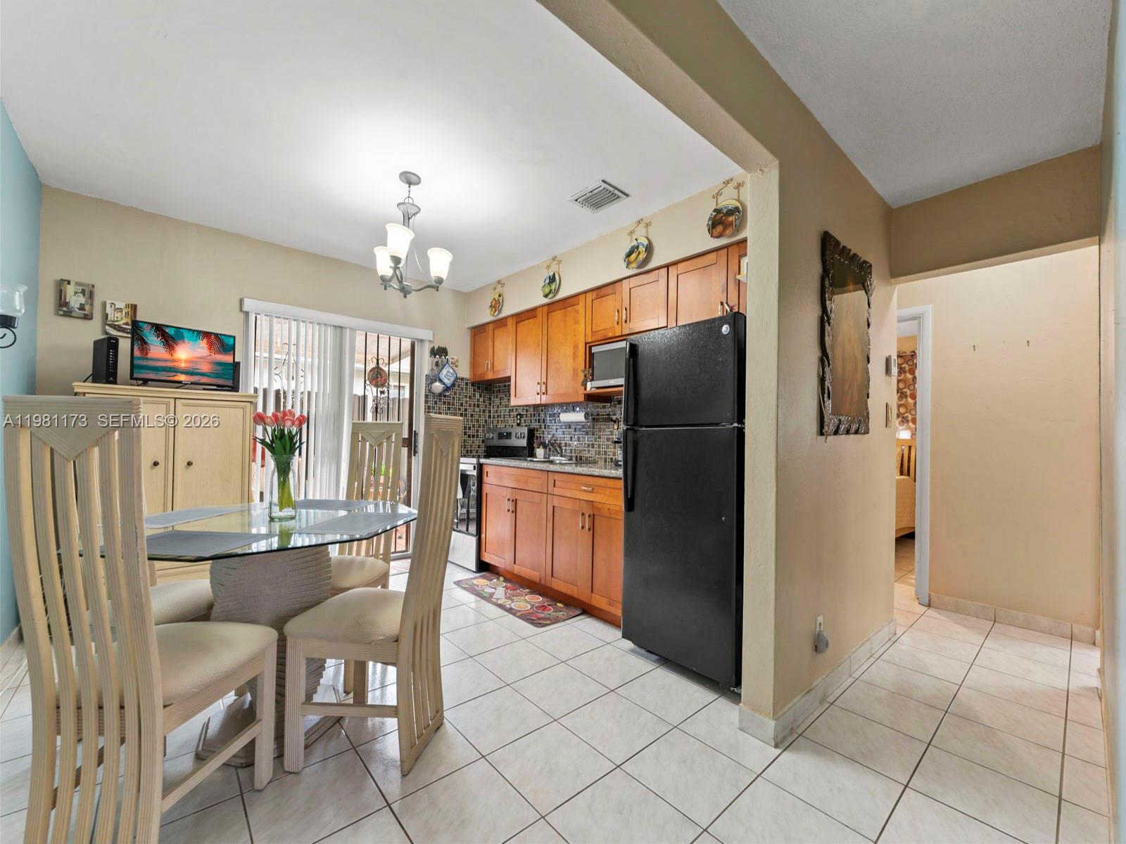27 East 12th Street Hialeah, FL 33010 - Photo 14 of 24 a kitchen with refrigerator cabinets and furniture
