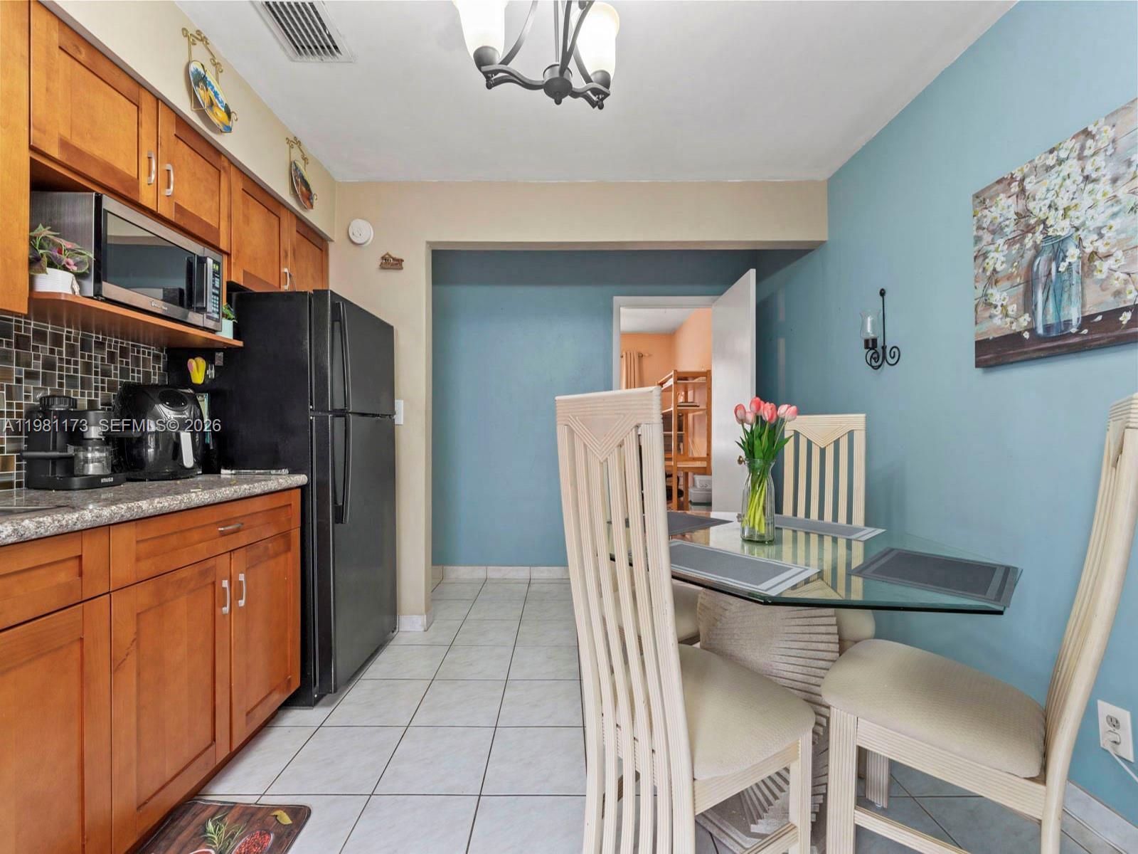 27 East 12th Street Hialeah, FL 33010 - Photo 15 of 24 a kitchen with stainless steel appliances granite countertop a refrigerator and a stove top oven
