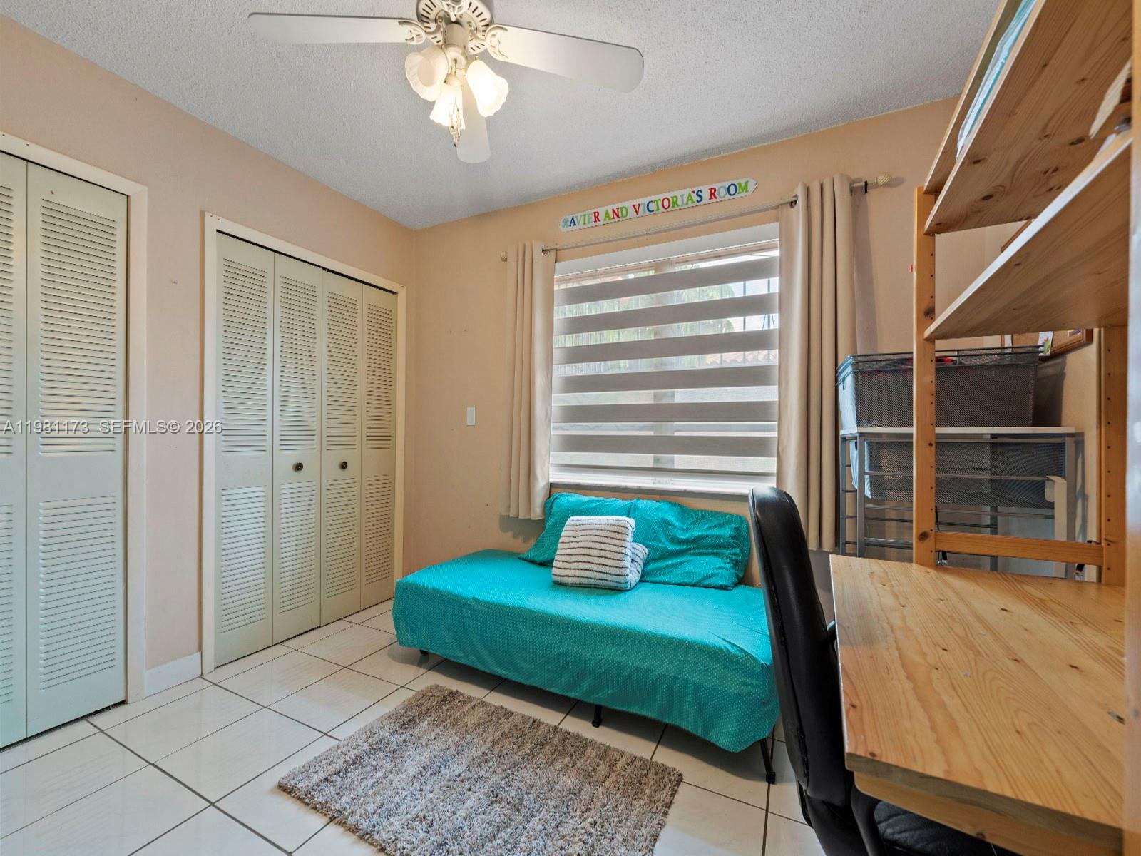 27 East 12th Street Hialeah, FL 33010 - Photo 16 of 24 a bedroom with a bed and a large window