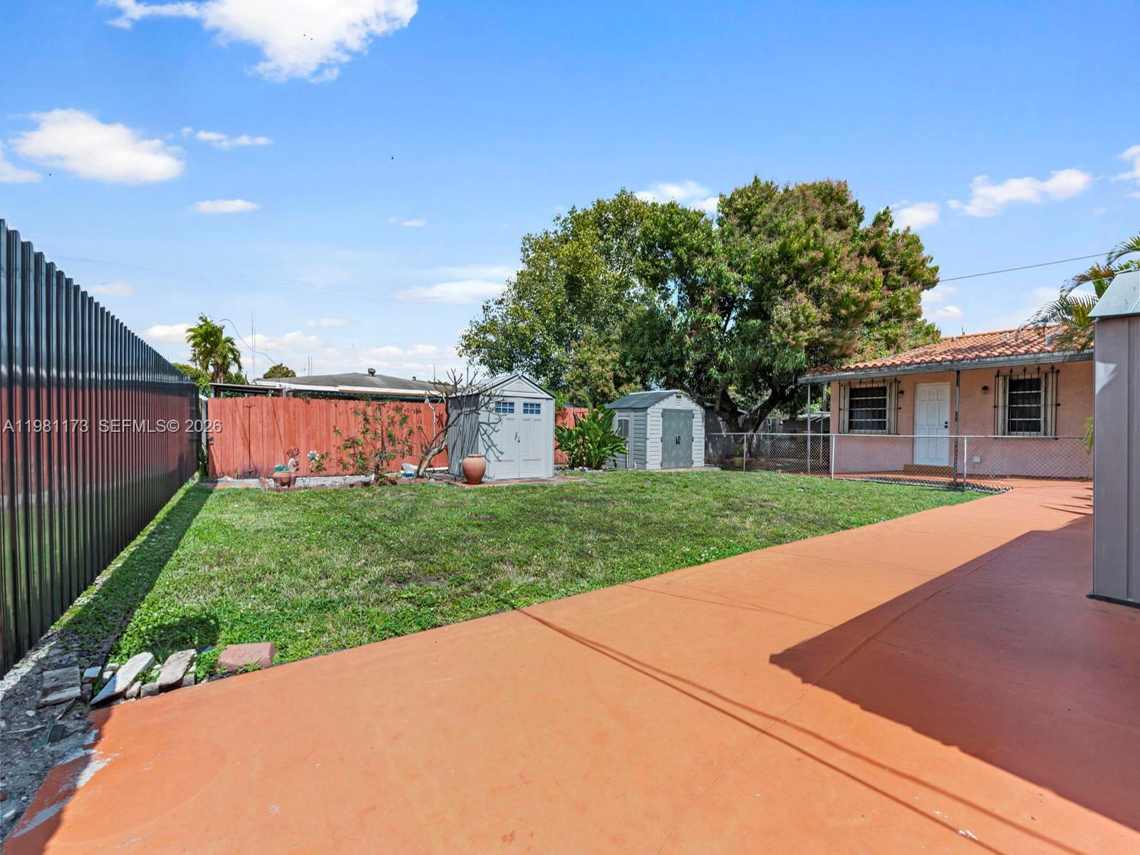 27 East 12th Street Hialeah, FL 33010 - Photo 19 of 24 a view of a house with backyard and a tree