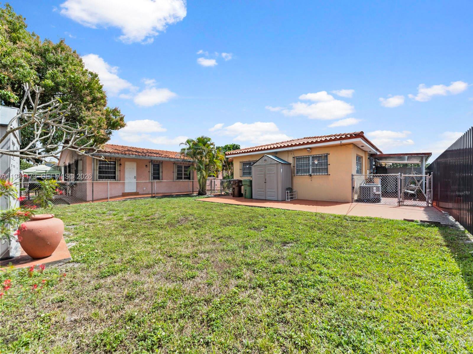 27 East 12th Street Hialeah, FL 33010 - Photo 20 of 24 a backyard of a house with table and chairs