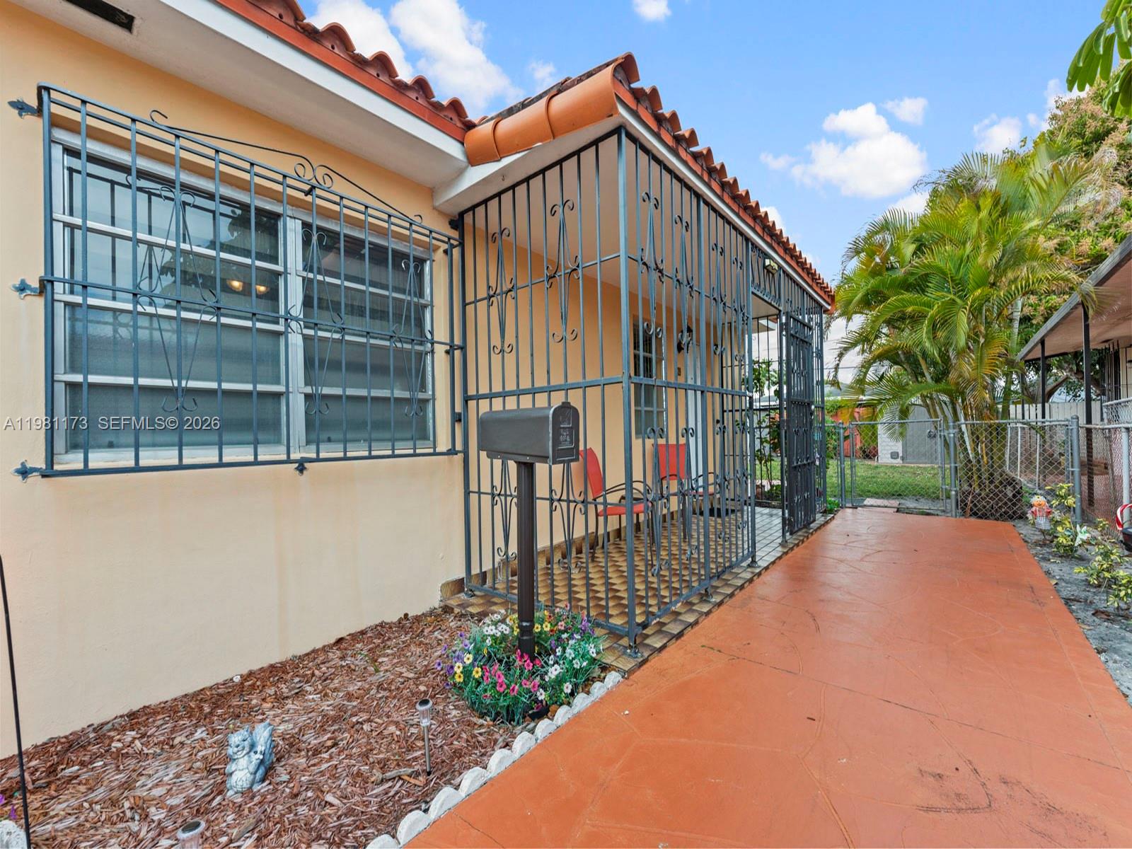 27 East 12th Street Hialeah, FL 33010 - Photo 21 of 24 a view of a house with a small yard and wooden fence