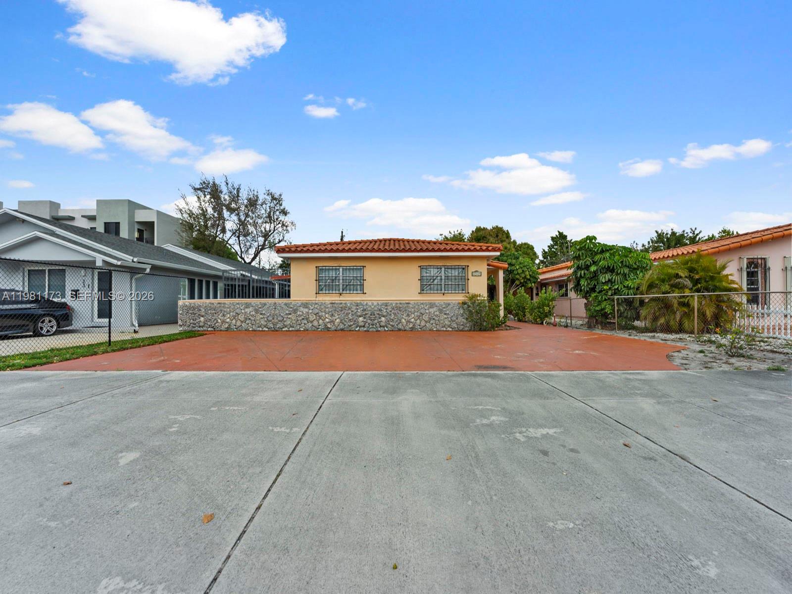 27 East 12th Street Hialeah, FL 33010 - Photo 24 of 24 a front view of a house with a yard and garage