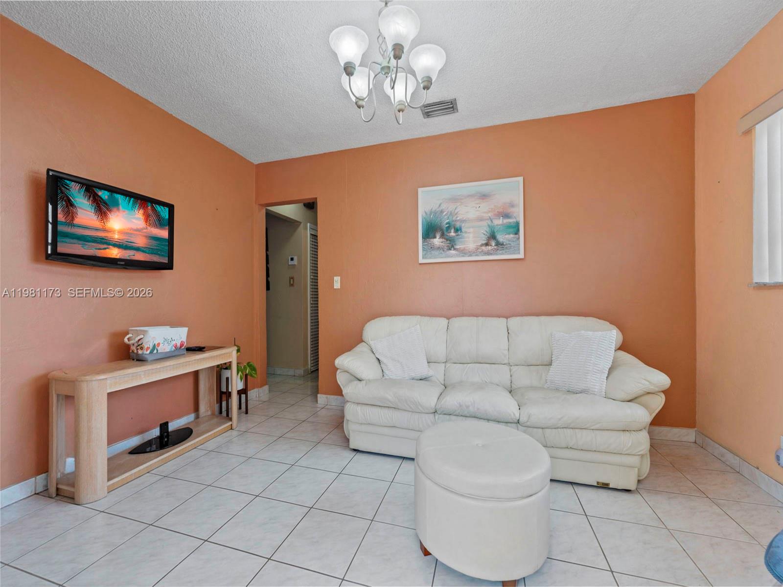 27 East 12th Street Hialeah, FL 33010 - Photo 8 of 24 a spacious bedroom with a bed and a couch