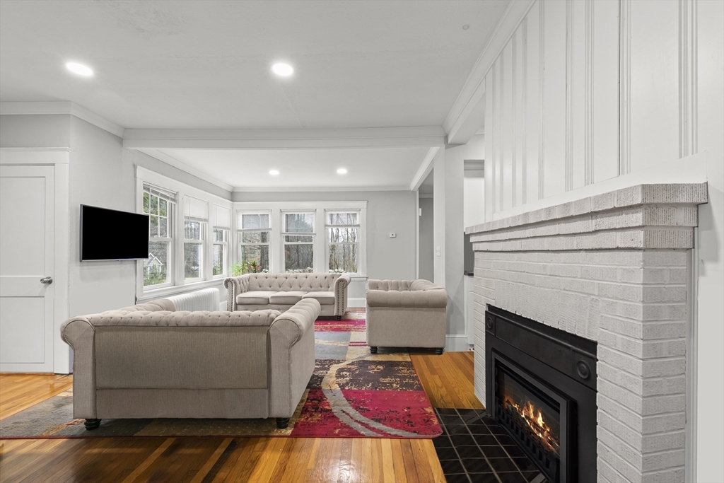 a living room with furniture a fireplace and a flat screen tv