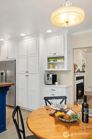 a kitchen with stainless steel appliances granite countertop a kitchen island a stove a table and chairs in it