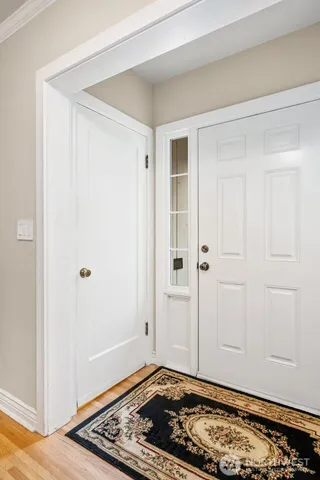 a view of staircase with lots of frames on wall and a window
