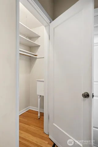 a hallway with a dining table and chairs
