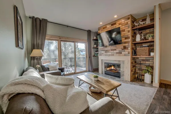 a living room with furniture fireplace and flat screen tv