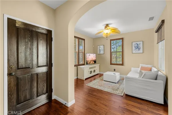 a living room with furniture and a chandelier