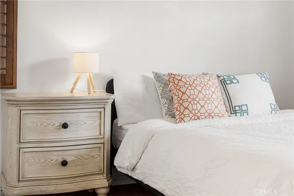 a bedroom with a bed and dresser