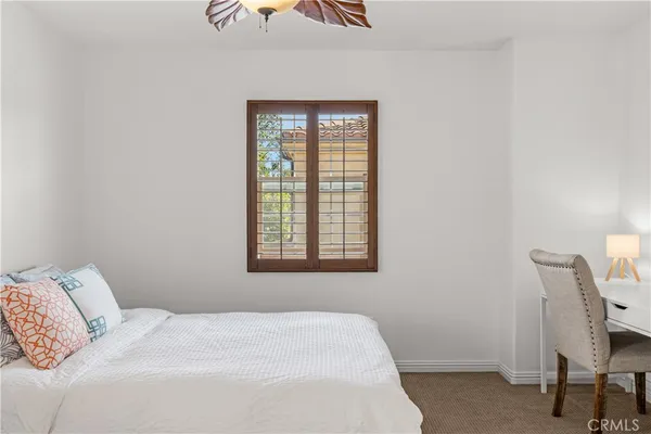 a bedroom with a bed a chair and a window