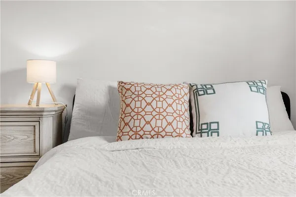 a bedroom with a bed and a lamp on table