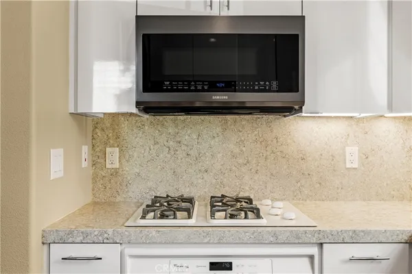 a kitchen with a stove and a microwave