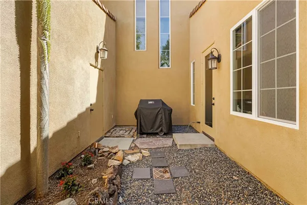 a view of a white house with a yard and large tree
