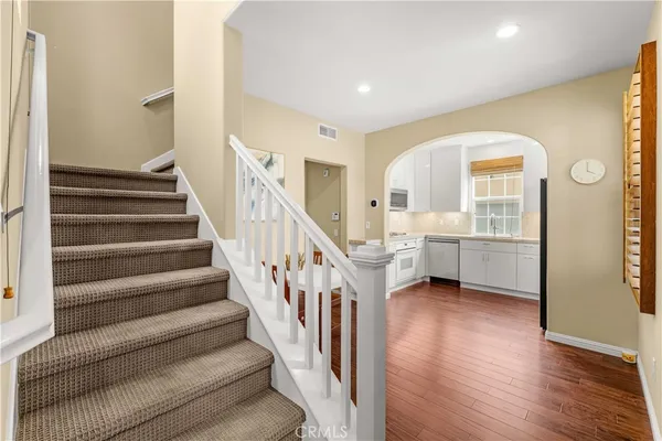 a view of entryway and hall with wooden floor