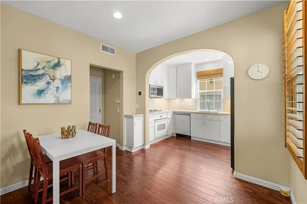 a view of a kitchen that has a table and chairs in it