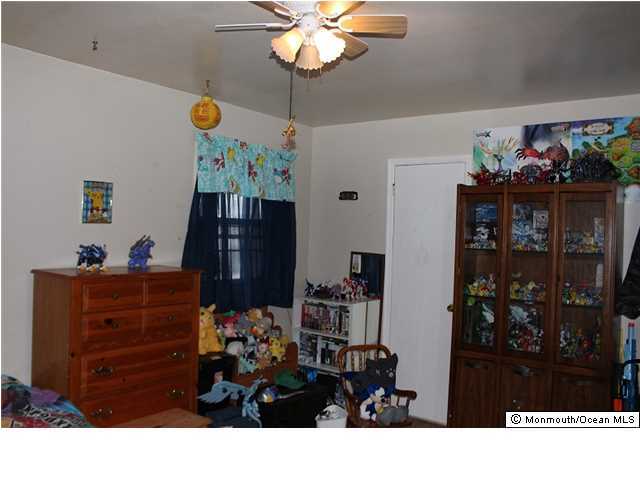 1137 Leonard Road Point Pleasant, NJ 08742 - Photo 12 of 25 a room with a table closet and a chandelier