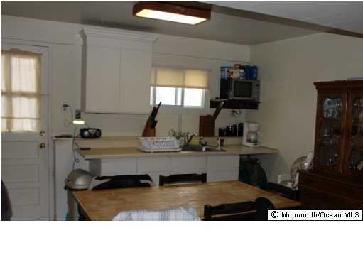 1137 Leonard Road Point Pleasant, NJ 08742 - Photo 19 of 25 a living room with furniture a flat screen tv and a sink