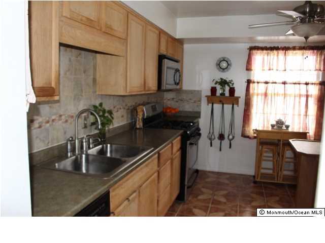 1137 Leonard Road Point Pleasant, NJ 08742 - Photo 4 of 25 a kitchen with a sink and cabinets