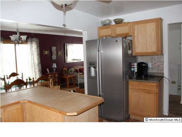 1137 Leonard Road Point Pleasant, NJ 08742 - Photo 5 of 25 a kitchen with stainless steel appliances kitchen island granite countertop a refrigerator and a sink