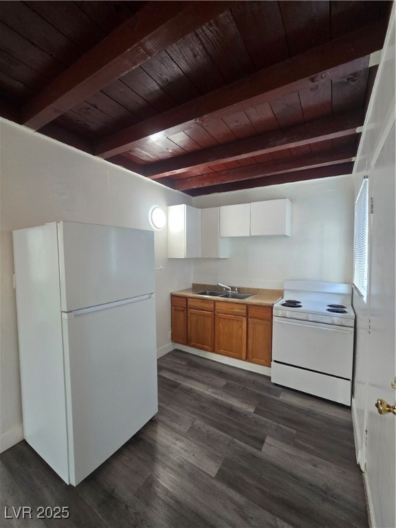 432 North 15th Street, Unit B Las Vegas, NV 89101 - Photo 5 of 9 Kitchen with refrigerator, white range oven, light countertops, brown cabinetry, and a wood ceiling with exposed beams