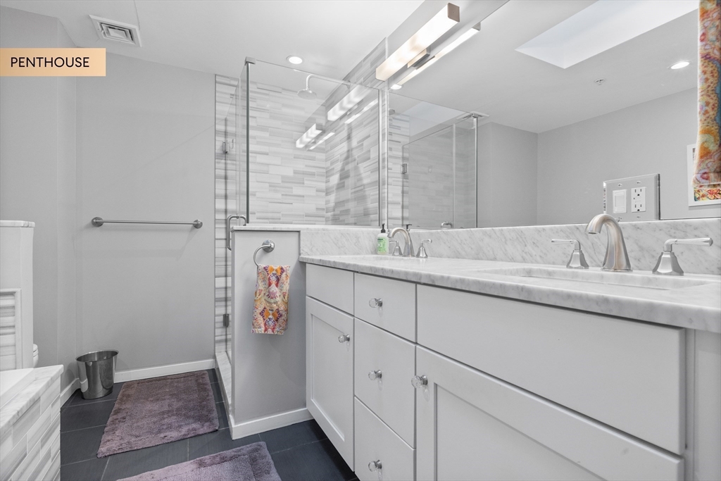 133 Salem Street Boston, MA 02113 - Photo 12 of 27 a bathroom with a sink double vanity and a shower