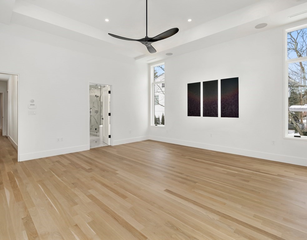 28 Eliot Road Lexington, MA 02421 - Photo 15 of 23 a view of an empty room with wooden floor and a window