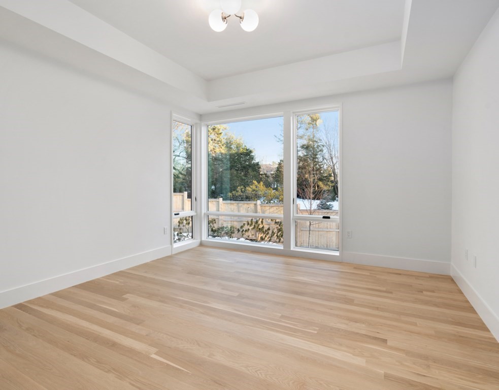 28 Eliot Road Lexington, MA 02421 - Photo 17 of 23 a view of an empty room with wooden floor and a window