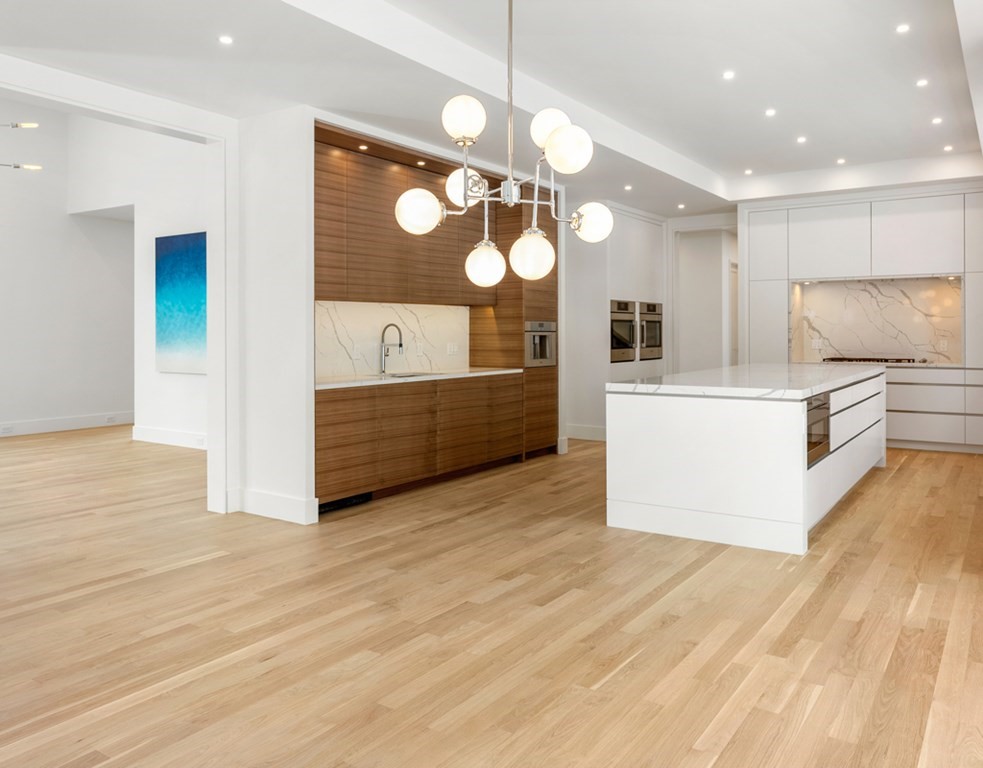28 Eliot Road Lexington, MA 02421 - Photo 8 of 23 a view of a kitchen with kitchen island a large counter top space appliances and cabinets