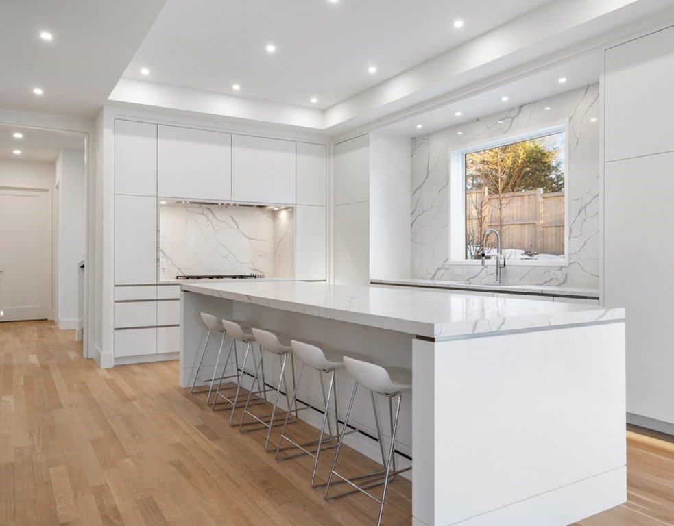 28 Eliot Road Lexington, MA 02421 - Photo 10 of 23 a kitchen with granite countertop white cabinets and white appliances