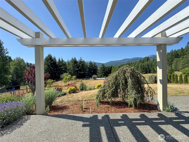 a view of a patio with table and chairs potted plants with wooden floor